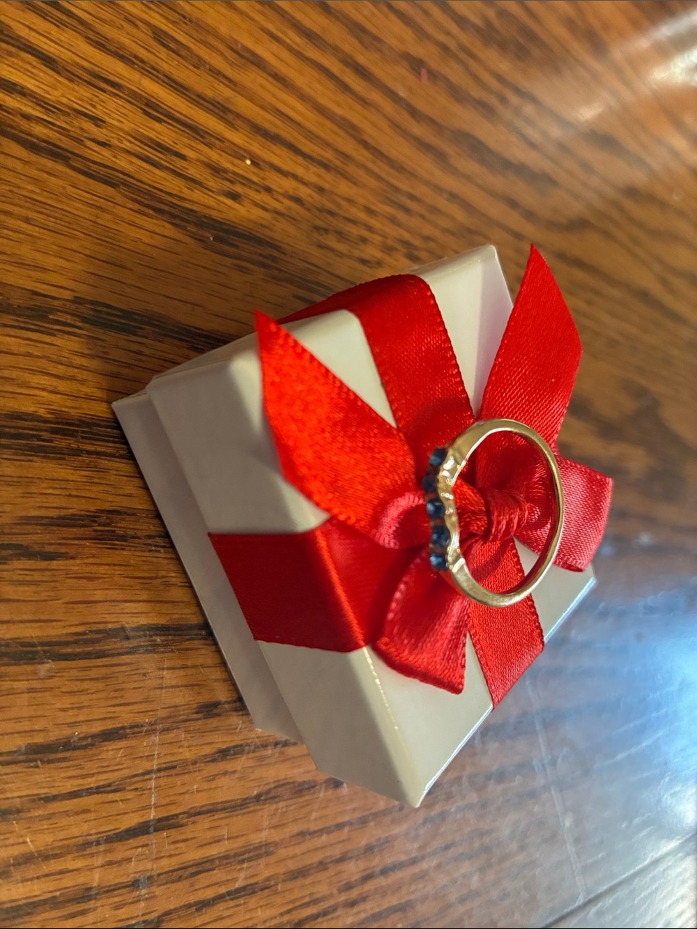 Gold Ring with Blue Stones on Red Bow Gift Box
